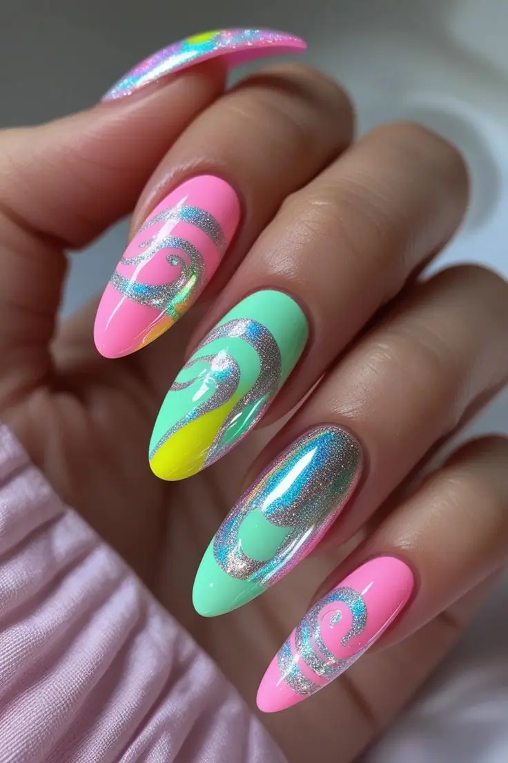 Close-up of a hand with long almond nails showcasing a holographic candy swirl nail art design in pastel pink, mint green, and yellow with silver mirror chrome lines, highlighting a trendy USA manicure style.