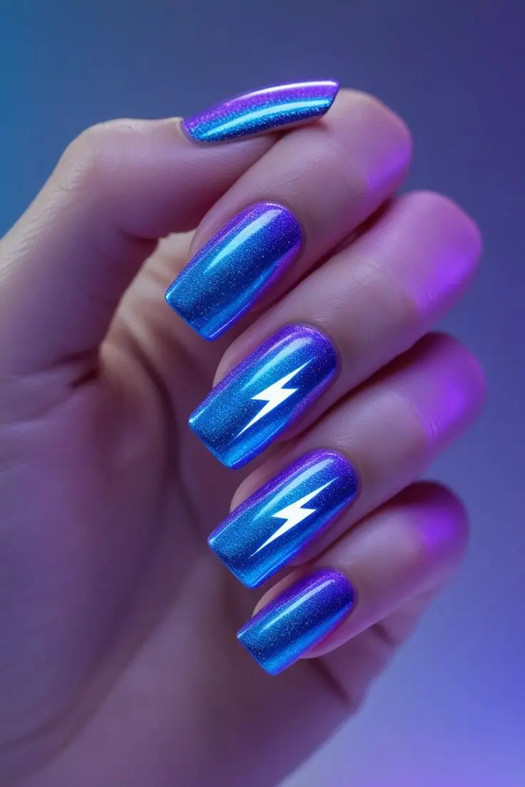Close-up of a hand with square-shaped nails featuring holographic electric pulse nail art with a neon blue and purple gradient, accented by white lightning bolt designs, showcasing a vibrant and trending look for US manicures.