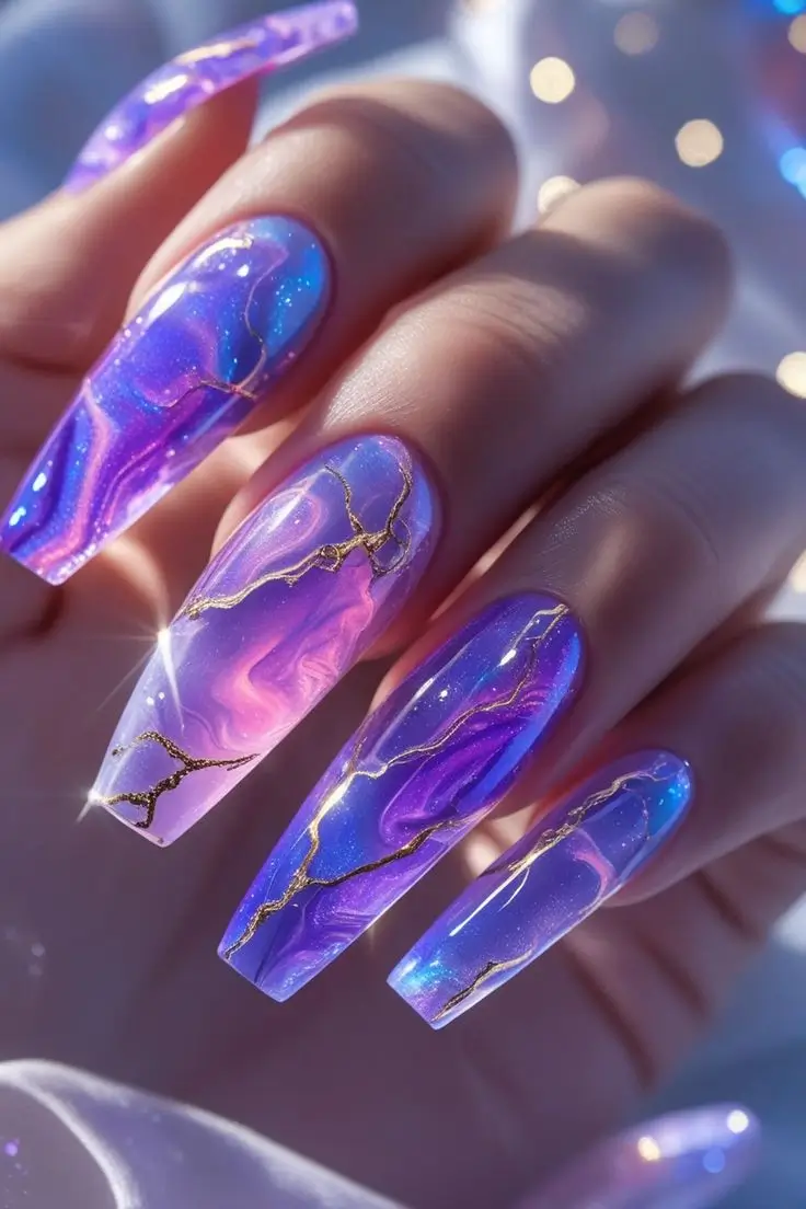 Close-up of a hand with long coffin nails featuring a purple and pink aurora marble nail art design, intricately detailed with shimmering gold veins for a luxurious and trendy US manicure.