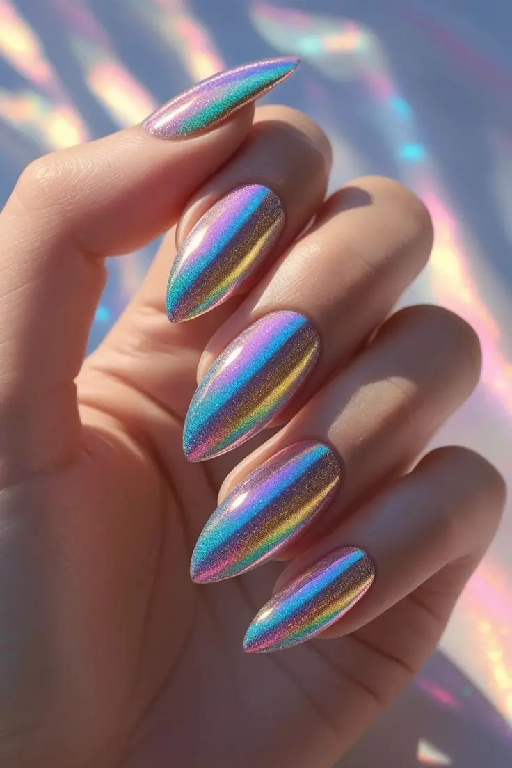 Close-up of a hand with long almond nails featuring a rainbow opal chrome nail art design with a vibrant holographic glow shifting through multiple colors, showcasing a dazzling and trending look for US manicures.