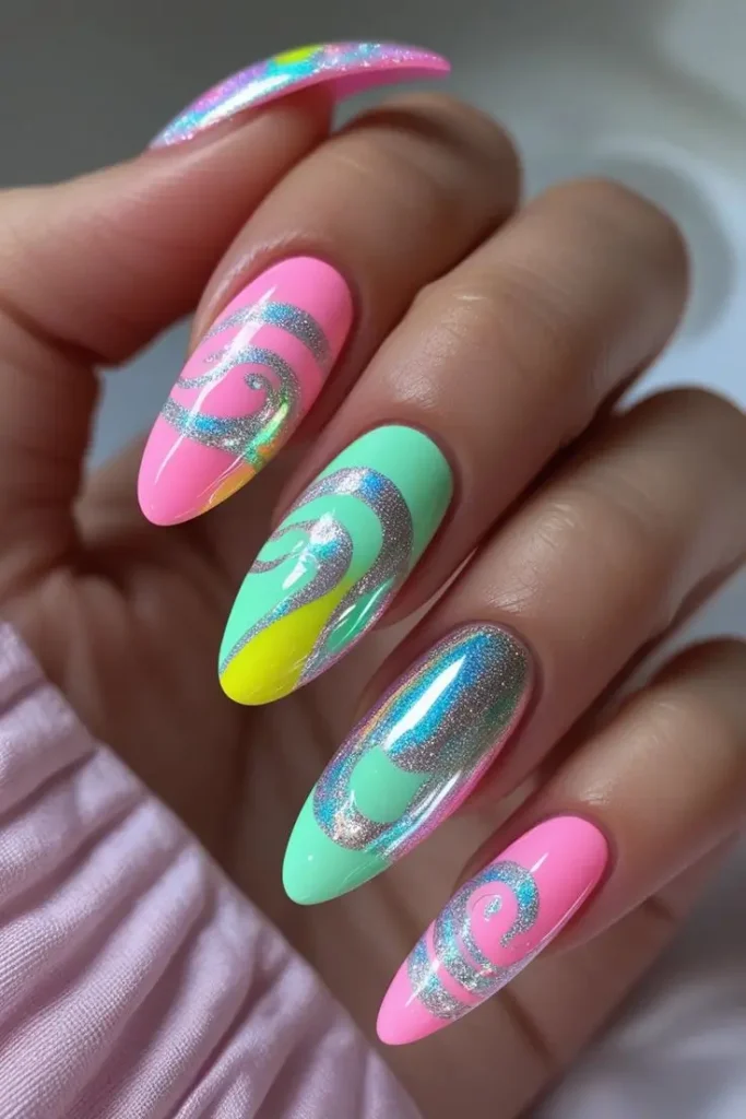 Close-up of a hand with long almond nails showcasing a holographic candy swirl nail art design in pastel pink, mint green, and yellow with silver mirror chrome lines, highlighting a trendy USA manicure style.