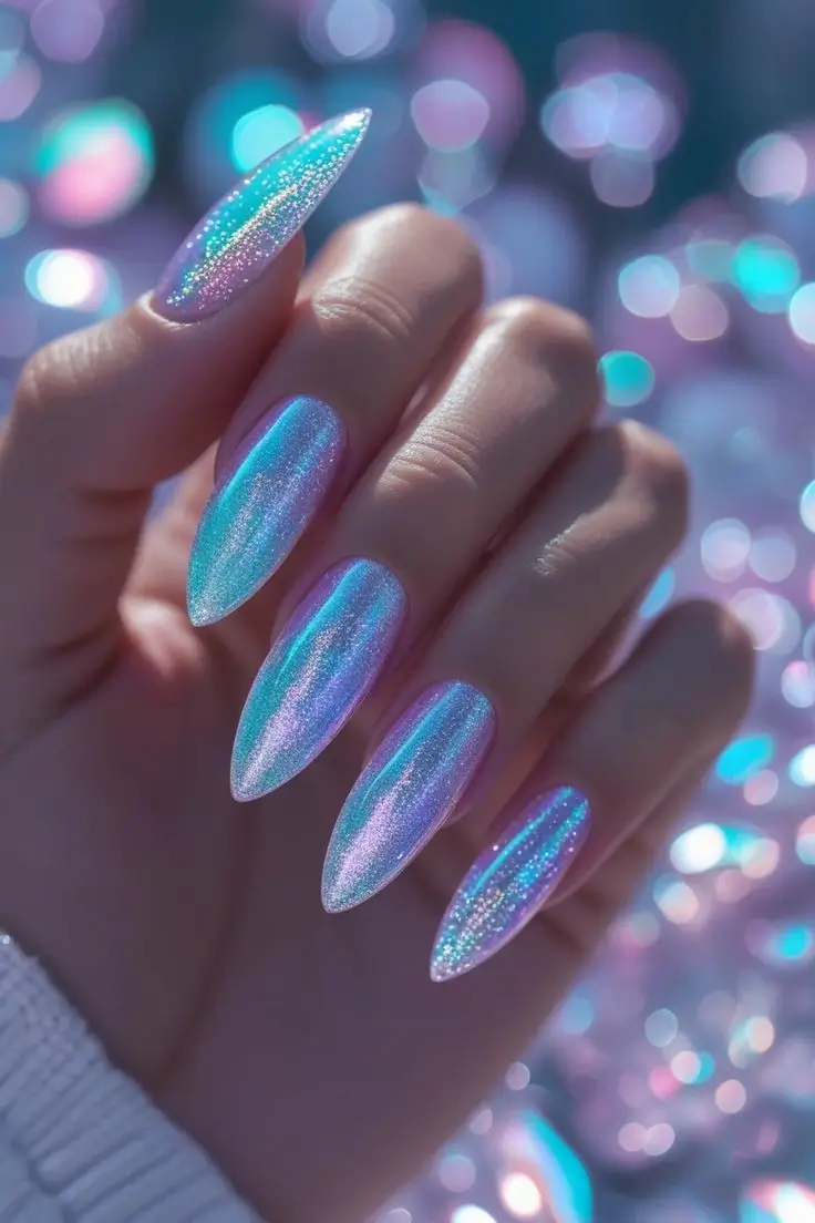 Close-up of a hand with long almond nails featuring holographic opal aurora nail art with an iridescent chrome glow shifting between blue, purple, and pink, showcasing a mystical and trending design for US manicures.