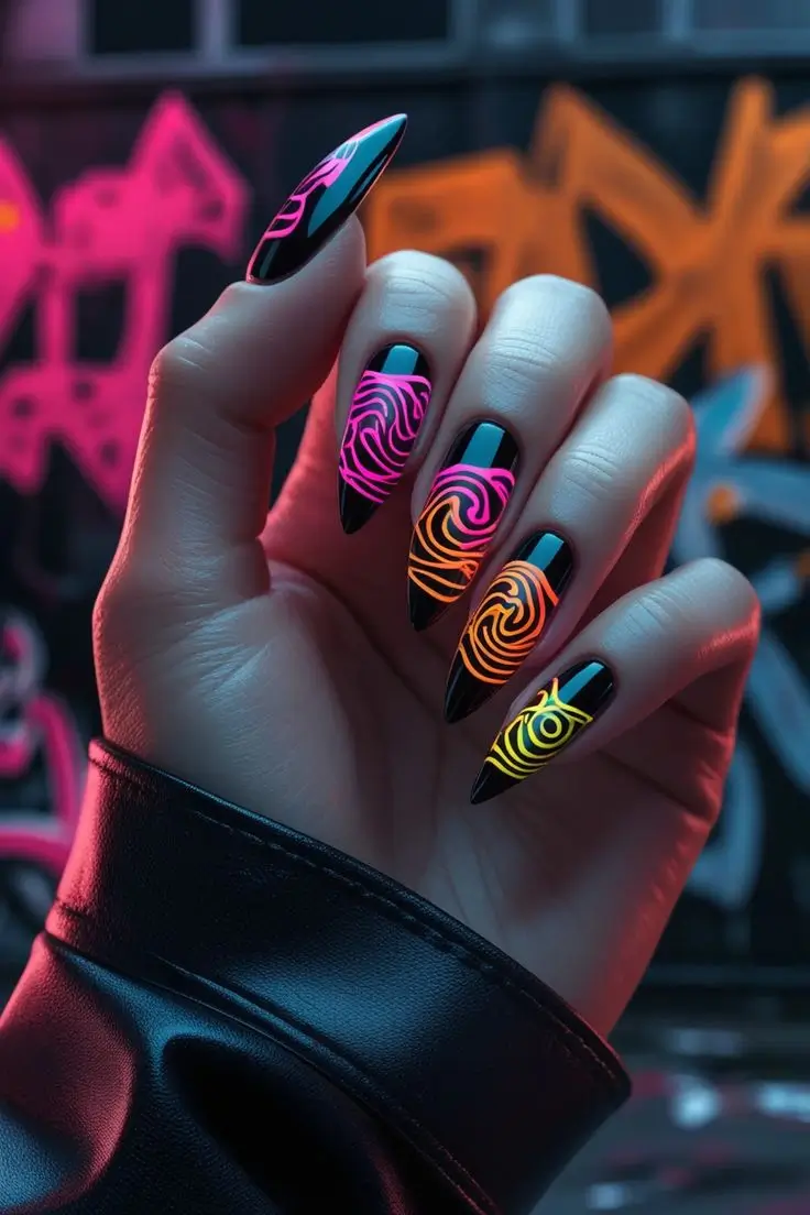 Close-up of a hand with long stiletto nails featuring neon lava wave nail art with a black base and glowing pink, orange, and yellow flame-like swirls, showcasing a bold and trending design for US manicures.